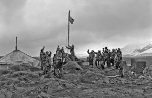 1947 Raising the flag, Atlas Cove, Heard Is., Admiralty Hut b/g © A. Campbell-Drury/ AAD